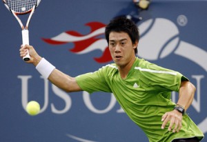 Nishikori of Japan returns a shot to Ferrer of Spain during their match at the U.S. Open tennis tournament at Flushing Meadows in New York
